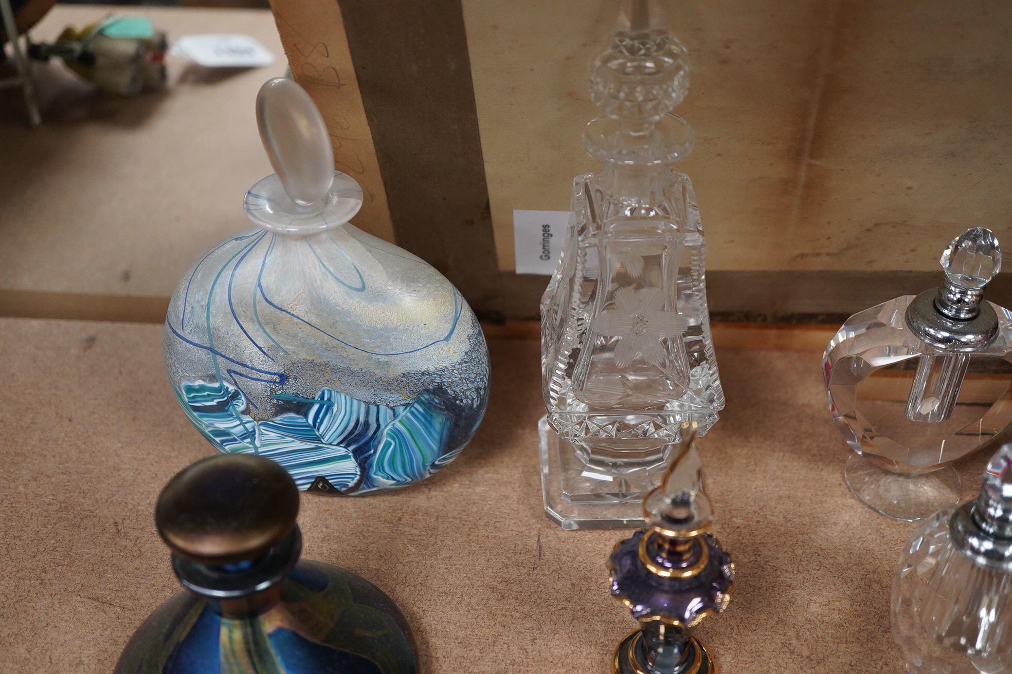 A collection of various glass scent bottles including a Lalique flower scent bottle and Bohemian examples, tallest 20.5cm. Condition - fair, some stoppers stuck